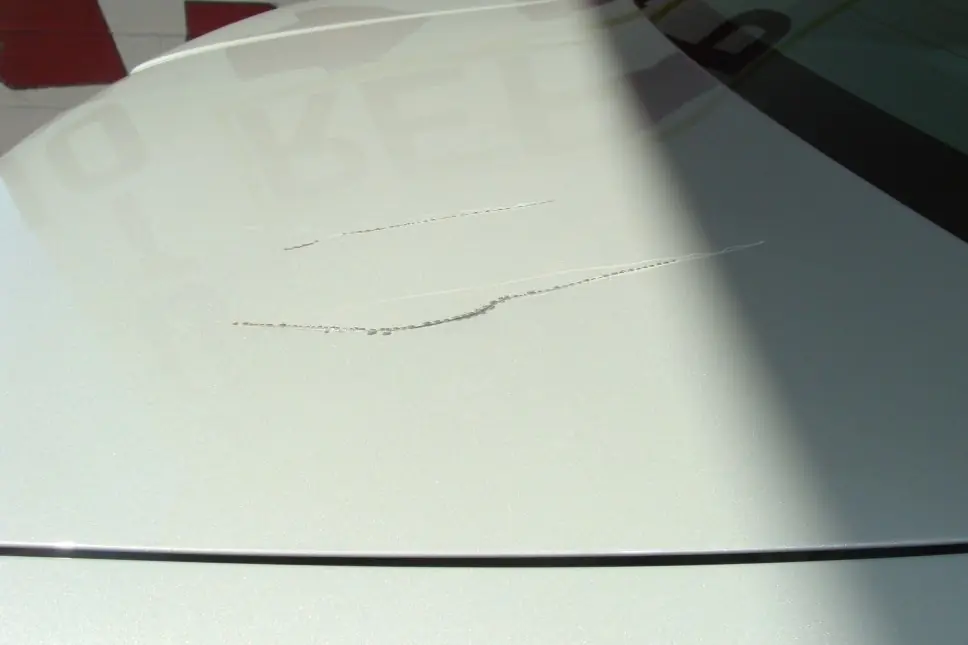 A light scratch across a white painted panel.