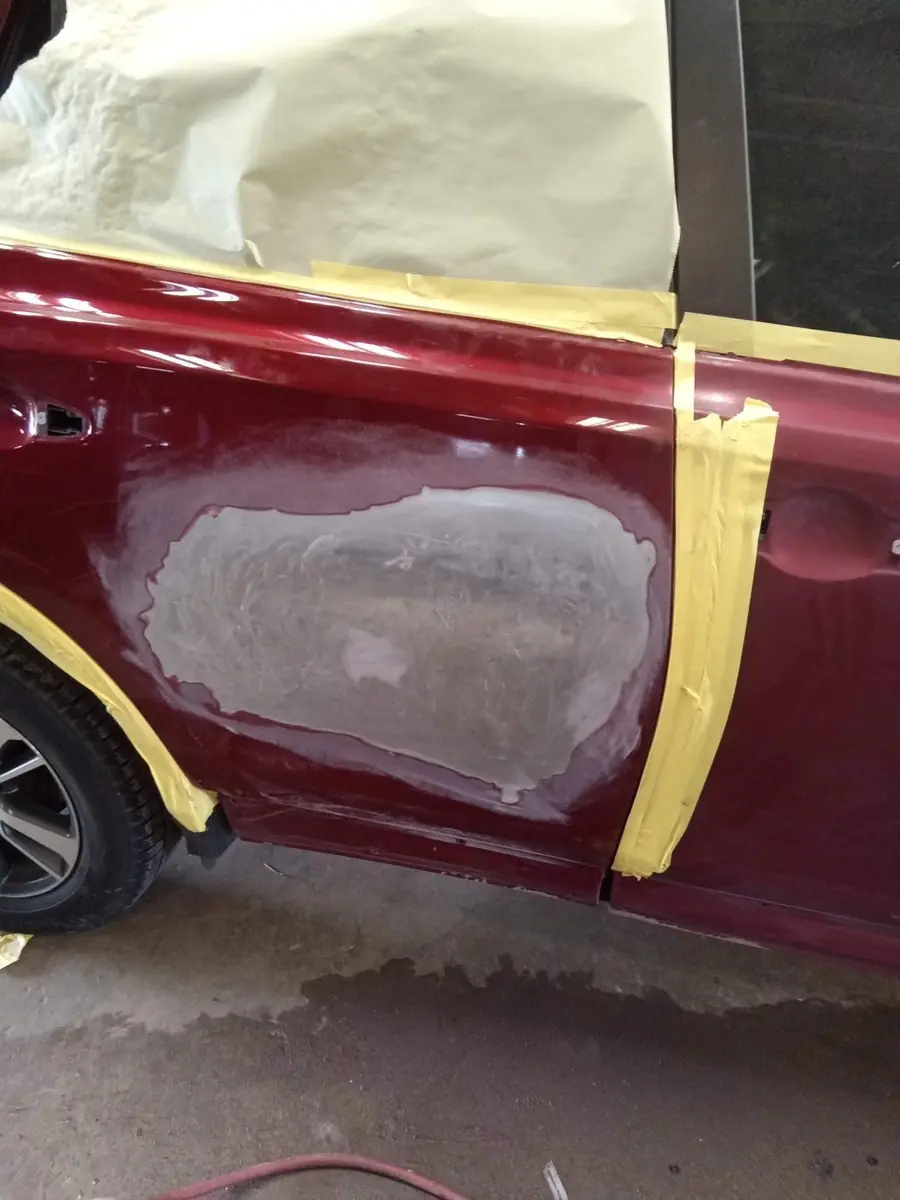 The door after body work, with filler shaped to the panel