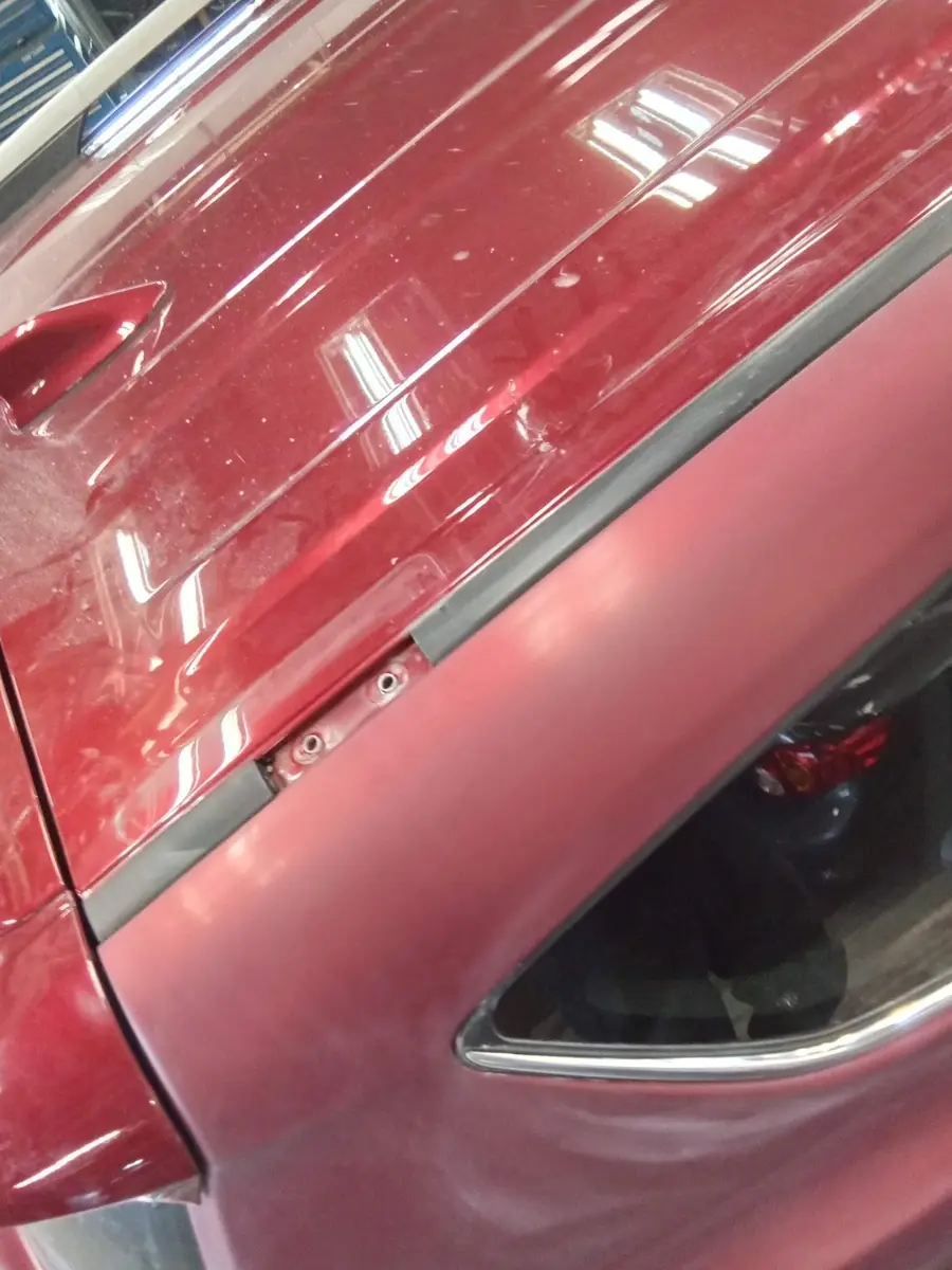Glossy red paint reflecting the shop lights