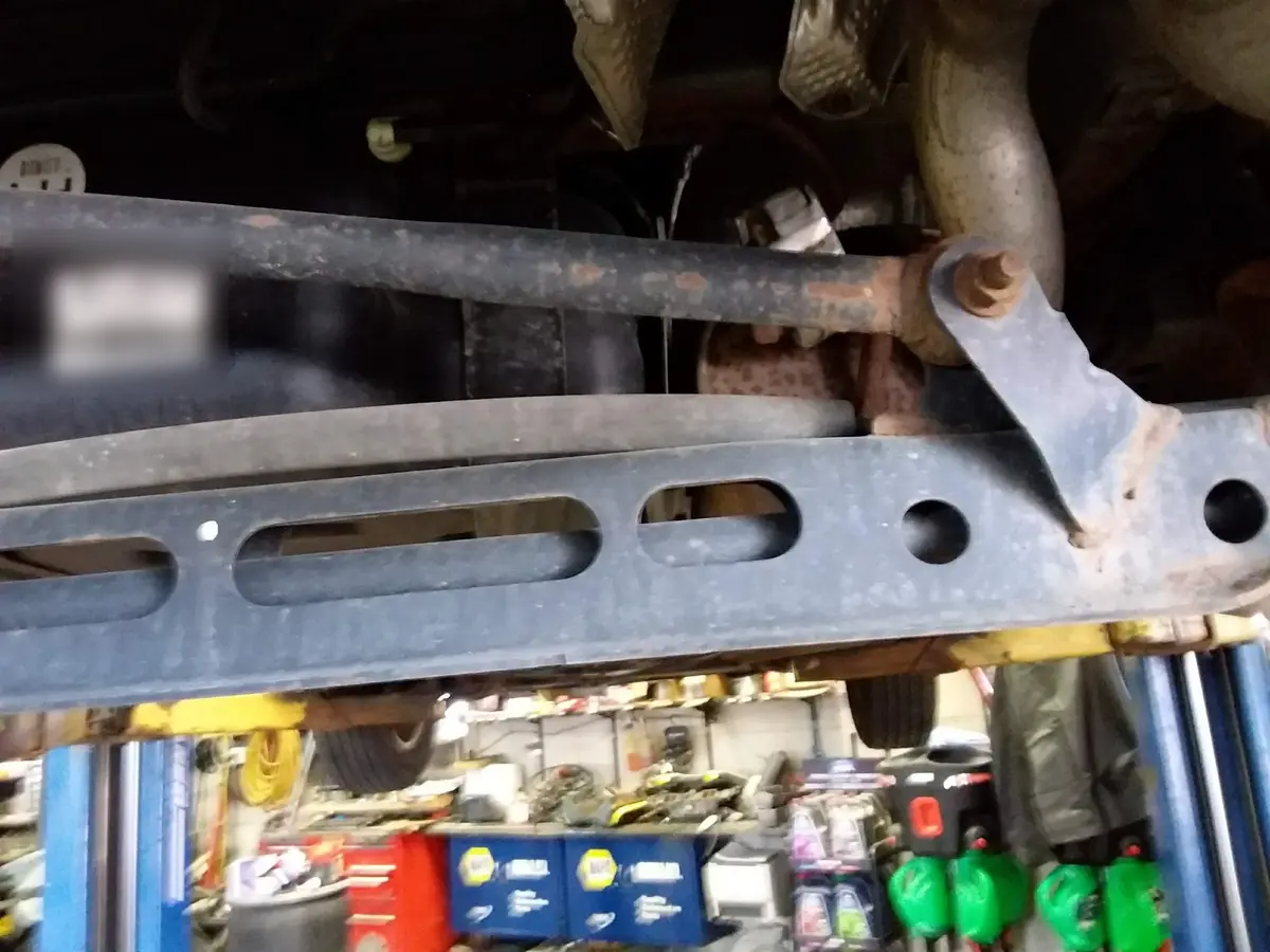 Suspension and frame components inspected on a lift