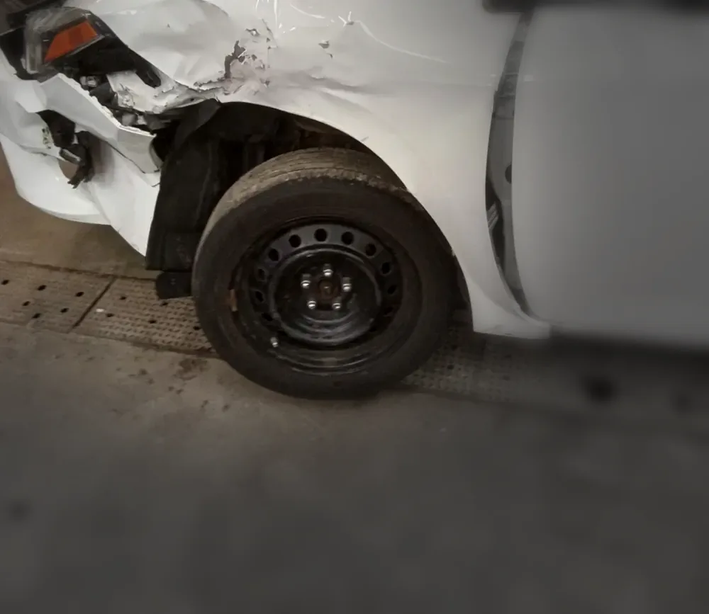 White sedan arriving with crushed front-corner damage