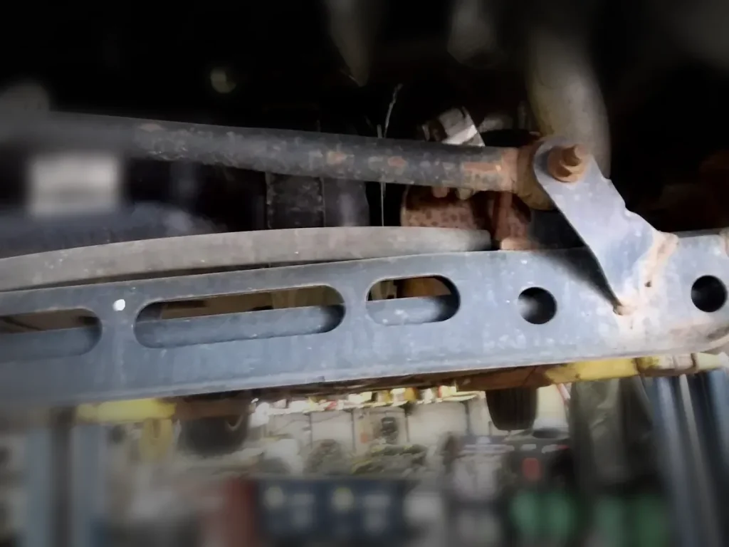 Suspension and frame components inspected on a lift